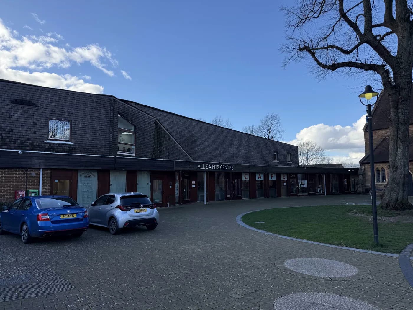 All Saints Centre and its main entrance from the village square