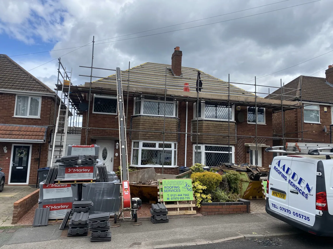 Aarden Roofing working on the roof of a house