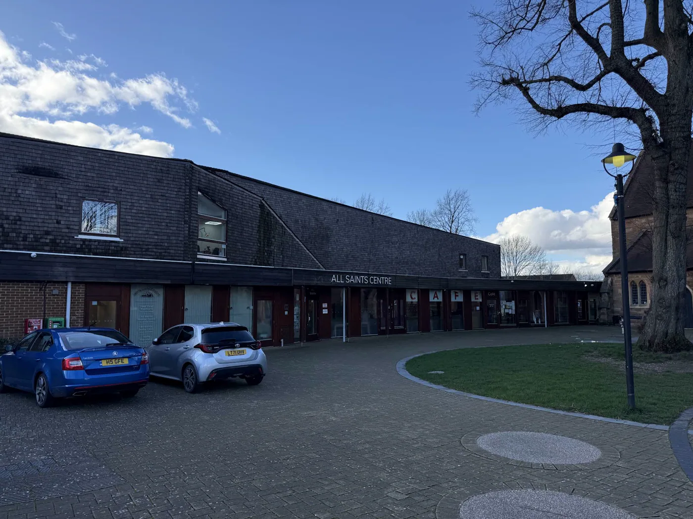 All Saints Centre and its main entrance from the village square
