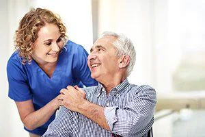 Care worker speaking with an older client at home