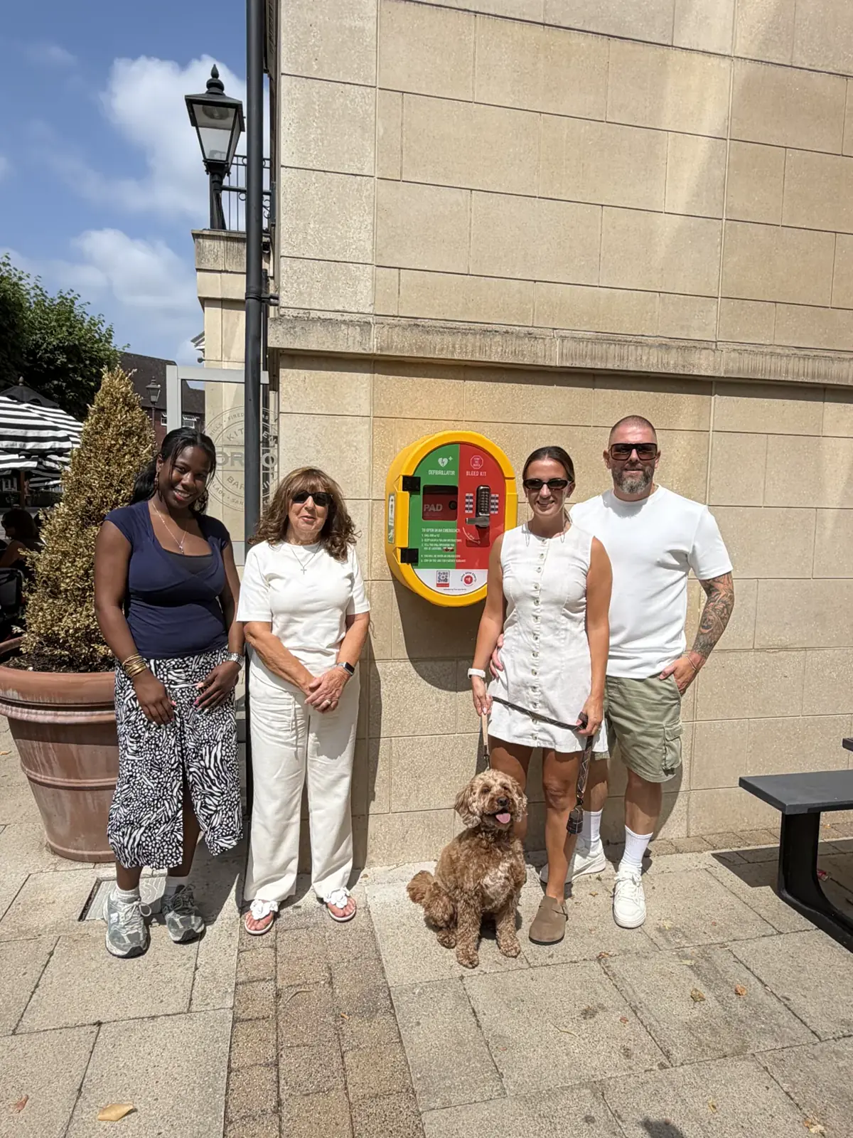Community supporters beside a public defibrillator funded by Arrive Alive