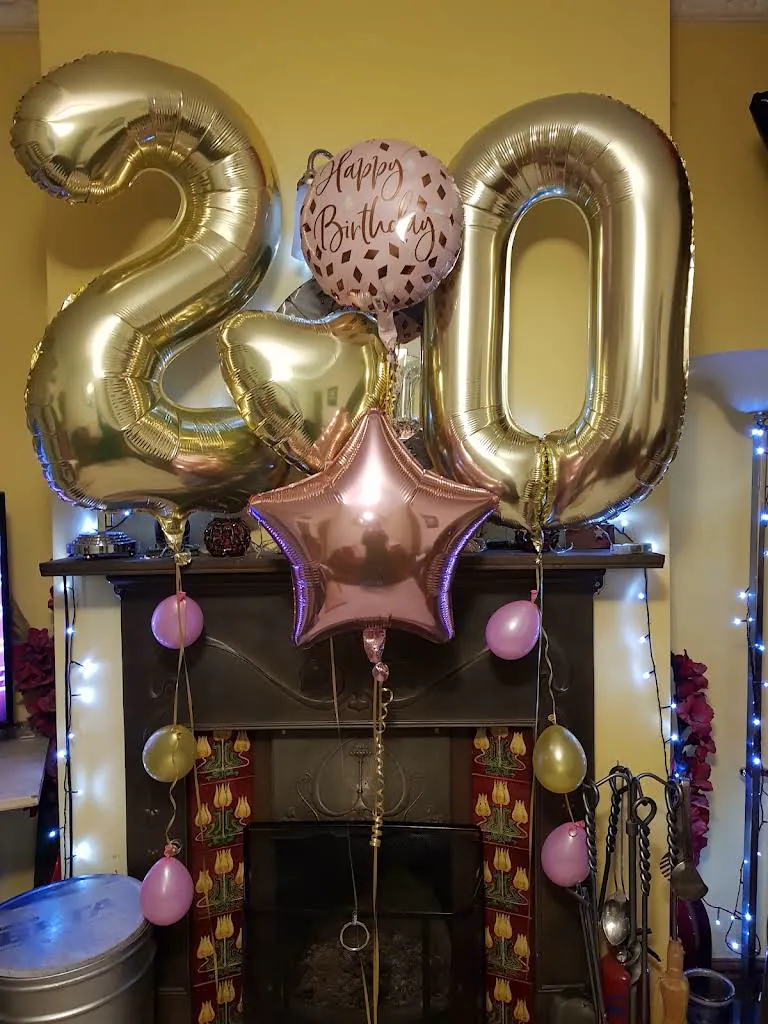 Gold number balloons and stars arranged for a twentieth birthday