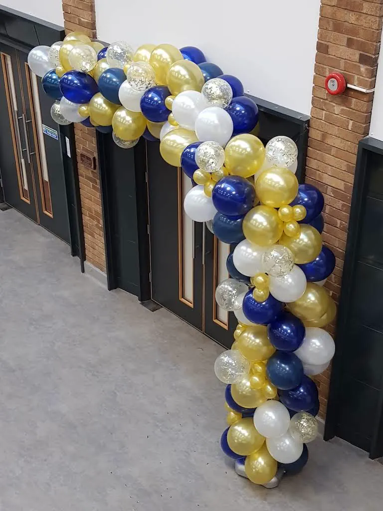 Blue, white and gold event balloon arch created by Balloon Away