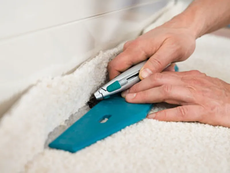 Carpet being professionally cut and fitted