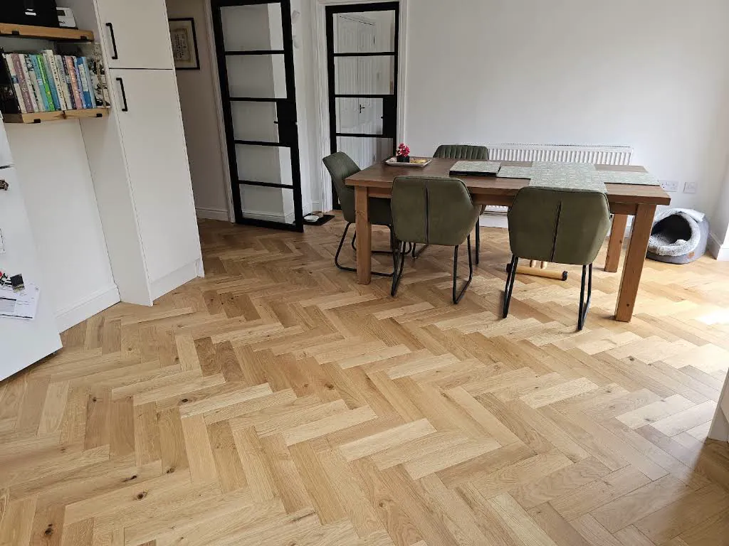 Herringbone wood flooring fitted in a dining room
