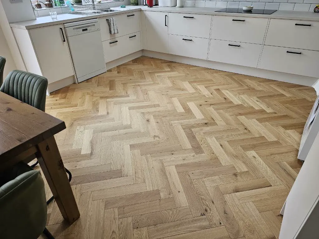 Herringbone wood flooring fitted through a kitchen