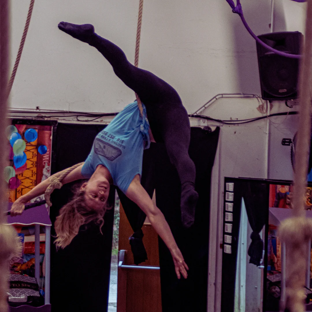 A CircusMASH participant performing an inverted trapeze pose