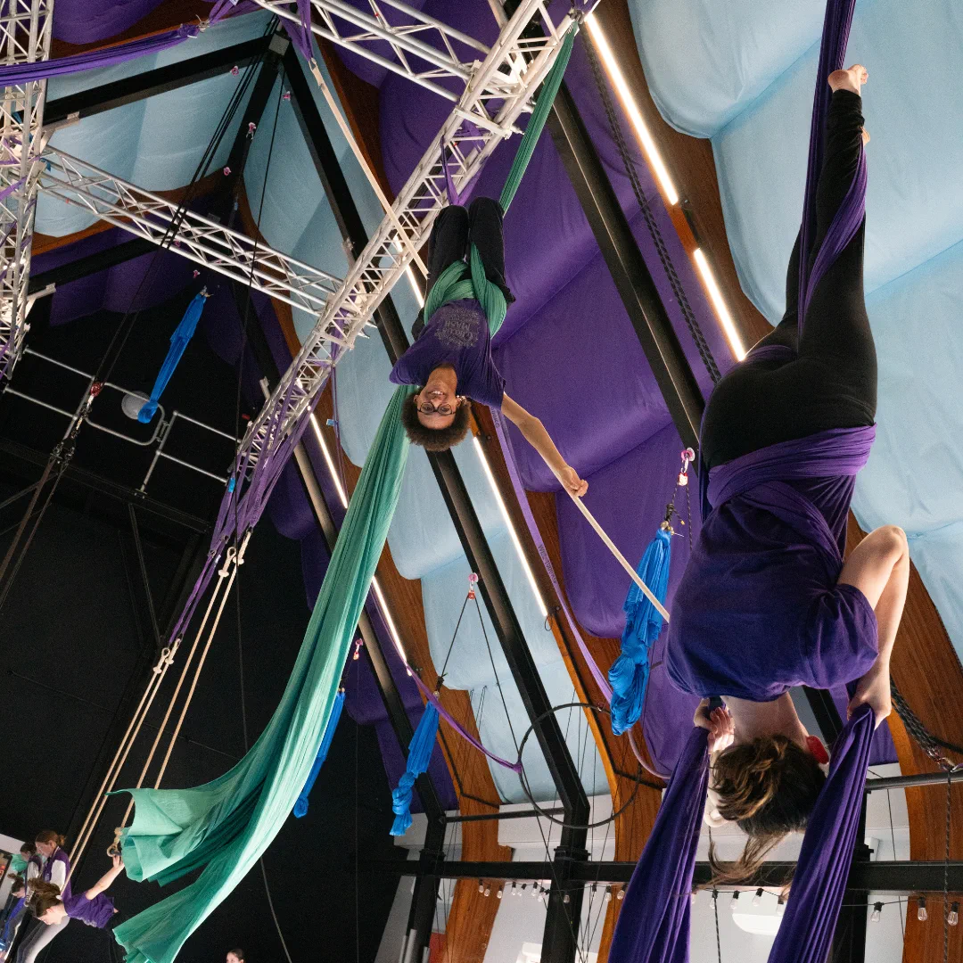 Young CircusMASH participants training together on aerial silks