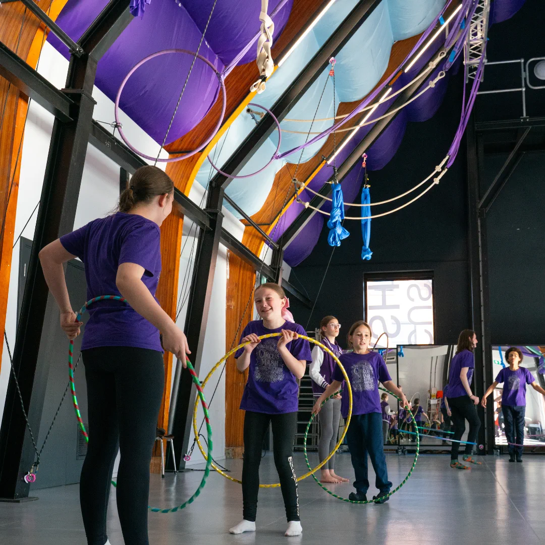 Young CircusMASH participants holding hoops during a class