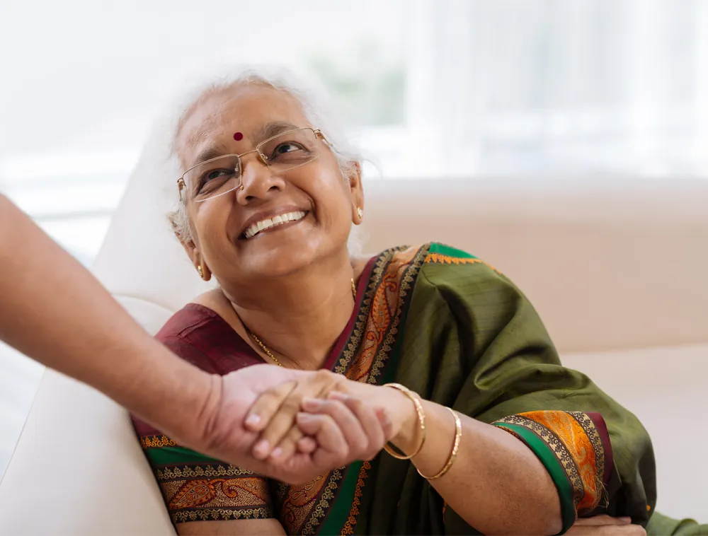 A home care worker greeting an older client