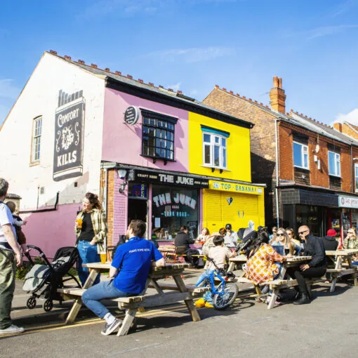 People enjoying outdoor tables on York Road in Kings Heath