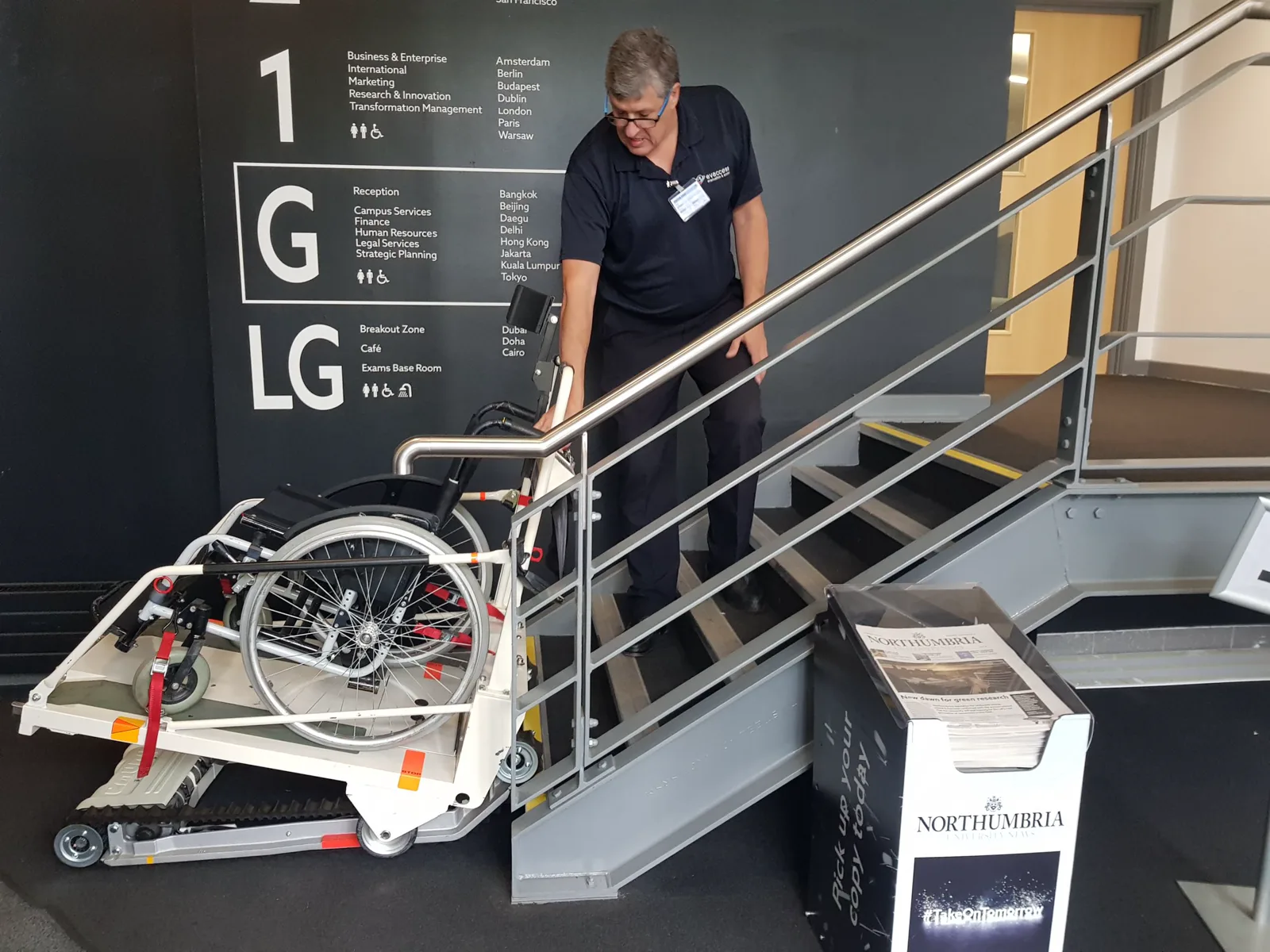 Evaccess demonstrating a powered stair climber with a wheelchair at Northumbria University