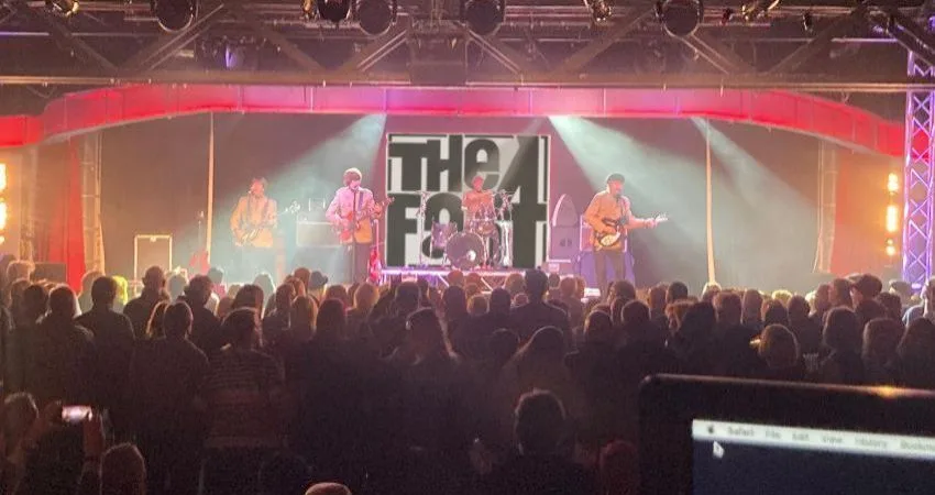The Fab 4 Beatles tribute band performing live on stage
