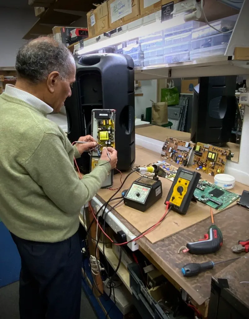 An engineer repairing electrical equipment at Skill Electronics