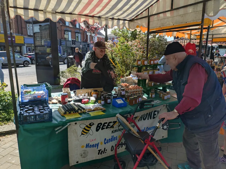 Beez Honey stall with jars of local honey, eggs and candles